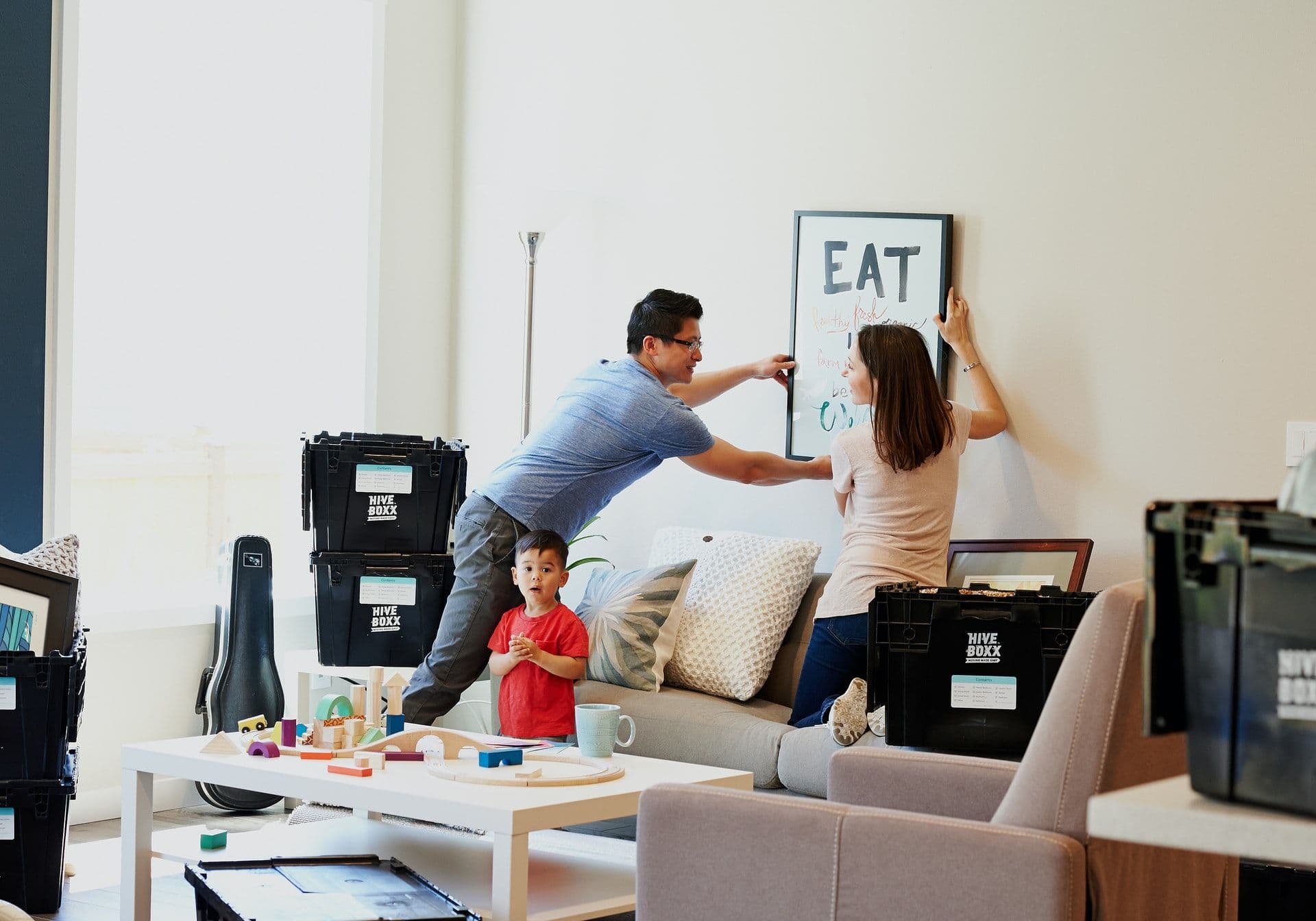 Familie beim Einrichten der neuen Wohnung mit Umzugsboxen